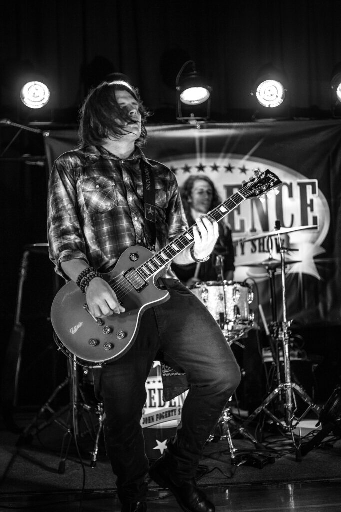 Black and white photo of Creedence - The John Fogerty Show