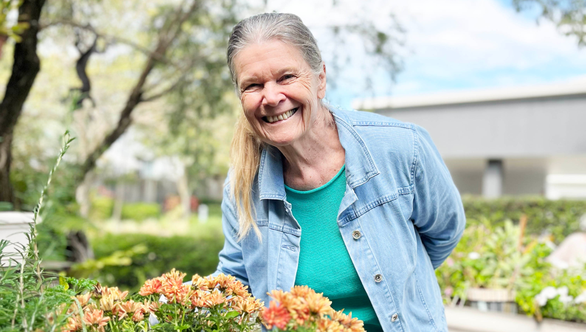 Photo of an all-smiles woman gardening